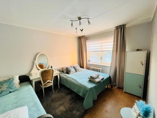 a bedroom with two beds and a mirror at Vabaduse apartment in Võru