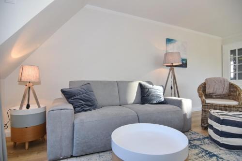 a living room with a couch and a table at Luv & Lee, Whg 10 in Westerland