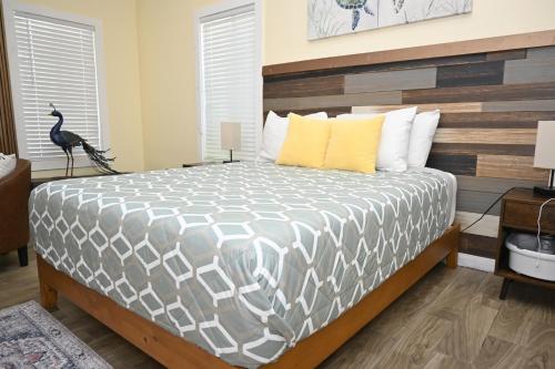 a bedroom with a large bed with a wooden headboard at Sunsetville in Savannah Sound