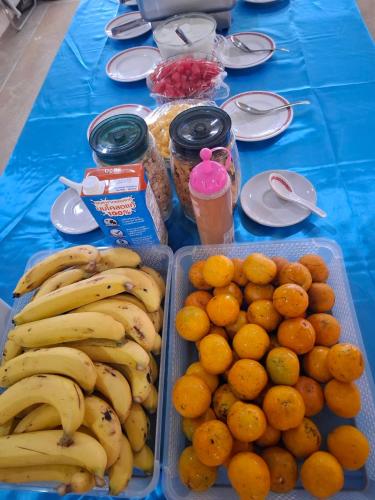 een tafel vol met bakken bananen en sinaasappels bij Lanta Summer House 1 in Koh Lanta