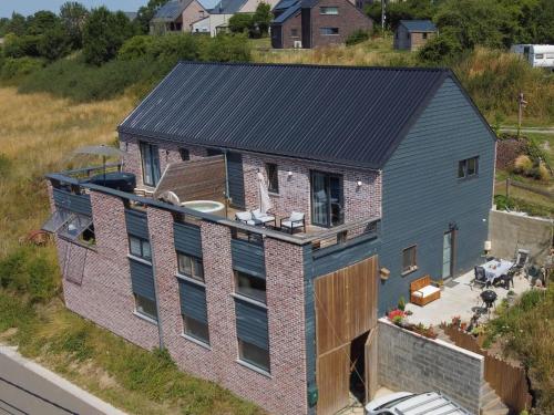 an aerial view of a house with a black roof at Appartement Terrasse Jacuzzi du Pont Alsort 2-1 in Froid-Chapelle