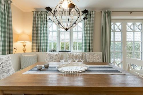 una sala da pranzo con un tavolo e un lampadario di Haus Landleben a Goting