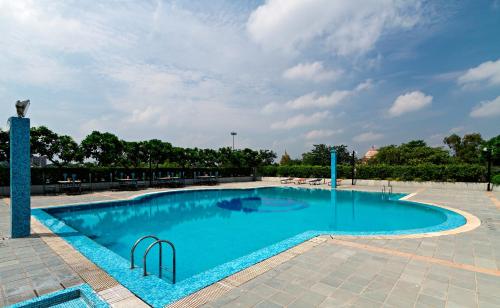 a large swimming pool with blue water at Clarks Avadh in Lucknow