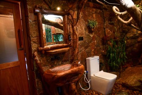 a bathroom with a wooden toilet and a window at Eco Cabins Hideaway Ella in Ella