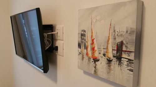a picture of a painting of boats on a wall at Fralillo House in Verona
