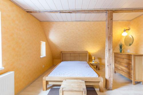 a bedroom with a bed and a table in it at Ferienhaus Klütz in Klütz