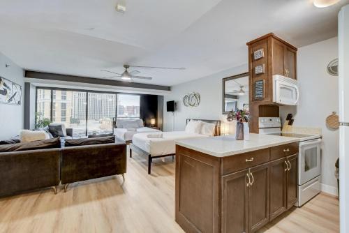 a kitchen and living room with a couch and a table at Stay Together Suites - Condominium Sleeps 14 with Iconic Vegas Views, Attached to The Cosmopolitan, NO RESORT FEES in Las Vegas