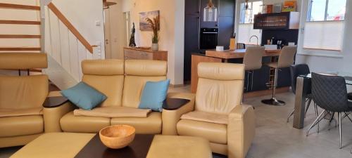 a living room with a couch and chairs and a table at Reethaus "Dat Lavendelhus" in Zierow