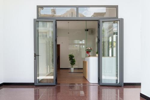 an open glass door in a building at HomyPlus Apartment in Ho Chi Minh City