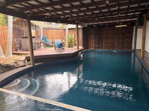 a swimming pool with a pergola and a patio at Tropical Spanish Style Cabana - New Listing! in Sydney