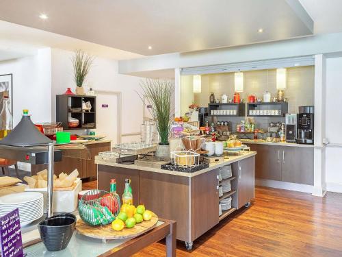 a large kitchen with a bunch of food at Mercure Northampton in Northampton
