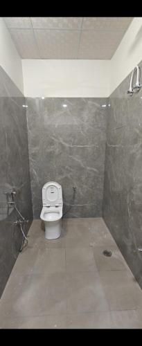 a bathroom with a toilet in a tiled room at Full villa welcome for you 4bhk available in Jaipur