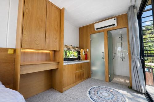 a bathroom with a shower and a sink in a room at Đất Quảng Villa in An Tân