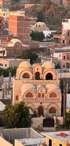 a large building on top of a city at Mystical habou domes villa private pool in Luxor