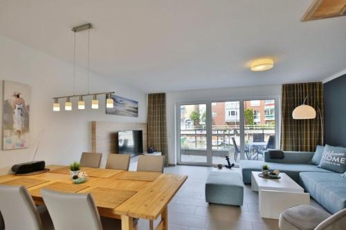 a living room with a table and a blue couch at City Marina, CM20a in Cuxhaven