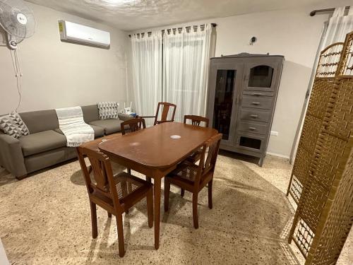 a living room with a table and chairs and a couch at Casa Linda in Campeche