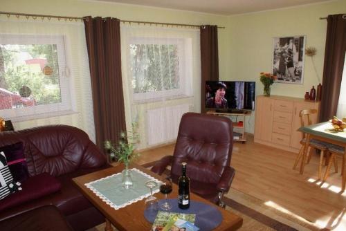 a living room with a couch and a table at Am Hang - ABC163 - nur Feriengäste! in Pinnow