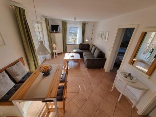 a living room with a couch and a table at Ferienhaus Sommerwiese - ABC327 in Klein Warin