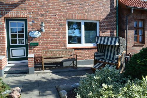 two benches sitting in front of a brick building at Fischers Fritz - Brückstr 32 in Heiligenhafen
