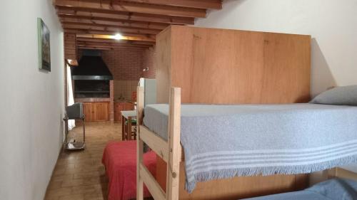 a bedroom with a bunk bed with a blue blanket at Departamento en barrio tranquilo in Mar del Plata