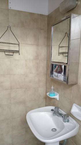 a bathroom with a sink and a mirror at Departamento en barrio tranquilo in Mar del Plata