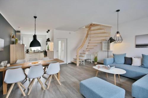 a living room with a blue couch and a table at City Marina, CM20b in Cuxhaven