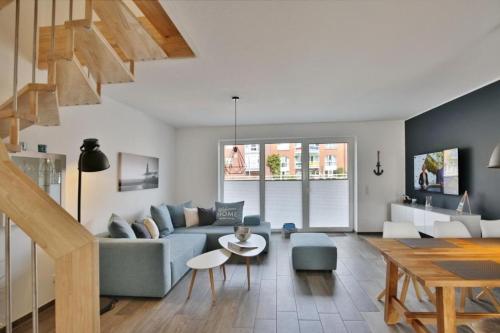 a living room with a blue couch and a table at City Marina, CM20b in Cuxhaven