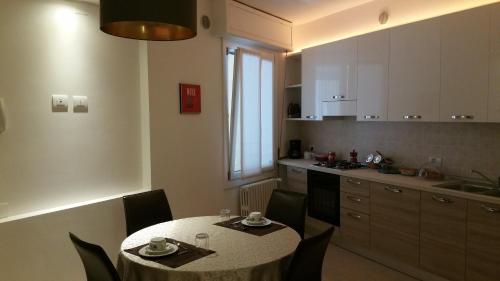 a kitchen with a table and chairs and a kitchen with a sink at Fralillo House in Verona