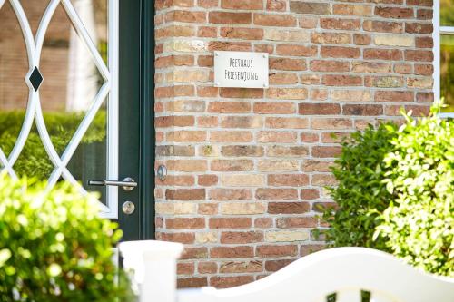a brick building with a sign that reads lawn therapy at Reethaus Friesenjung in Hedehusum