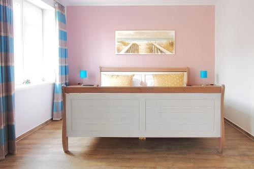 a dresser in a room with a wall at Amoy - Werftstraße 2 in Heiligenhafen
