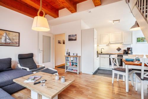 a living room with a couch and a table at Südstranddomizil 56 in Wyk auf Föhr