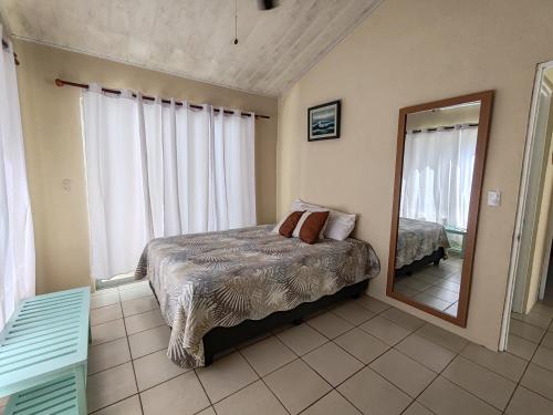a bedroom with a bed and a large mirror at Casa Tribu in Agujas