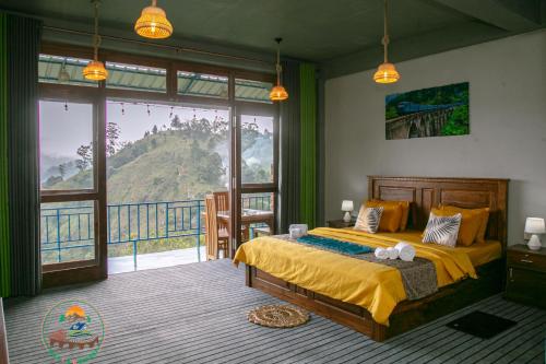 a bedroom with a bed with a view of a mountain at Ella T&D Resort in Ella