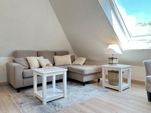 a living room with a couch and two tables at Sinfonie, Whg 5 in Tinnum