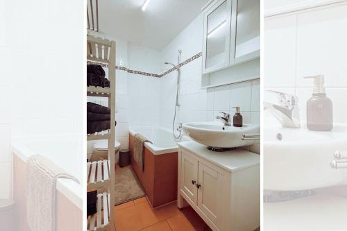 a white bathroom with a sink and a toilet at Niedere Burgstraße - im Herzen der Altstadt in Pirna