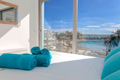 a room with a large window with a view of a pool at Apartments Beach 4U - Can Pastilla in Can Pastilla