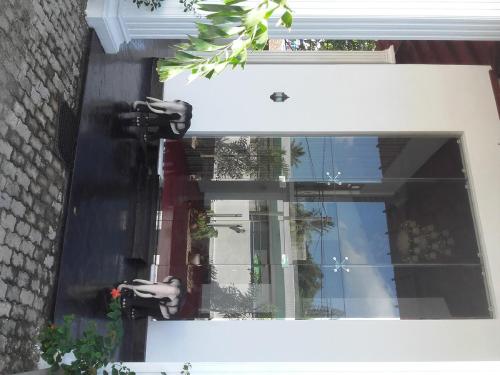 a window of a building with two birds on it at The Kingston Hotel in Kiribathgoda