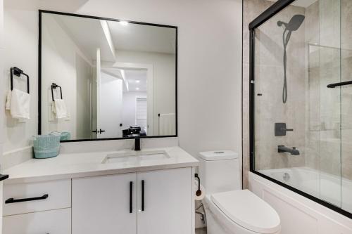 een witte badkamer met een wastafel en een douche bij Metrotown area in Vancouver