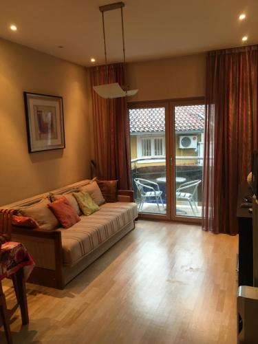 a bedroom with a bed and a sliding glass door at Zaga Solemar Apartment in Herceg-Novi