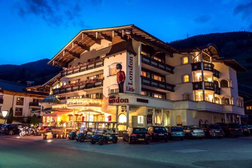 a large building with cars parked in front of it at Hotel CENTRAL Bar & Restaurant in Gerlos