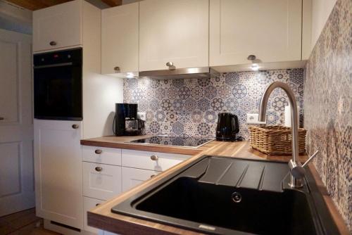 a kitchen with a sink and a counter top at Hygge in Boldixum