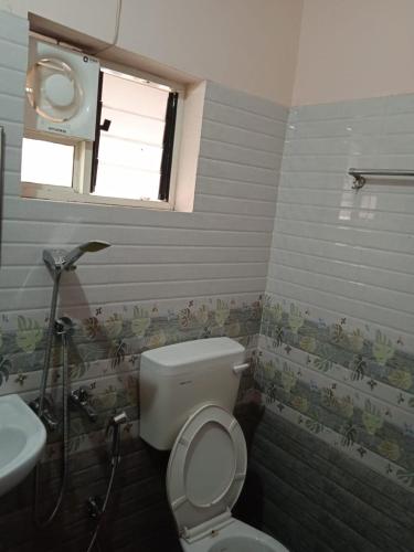 a bathroom with a toilet and a sink at Sakalam homestay in Trivandrum