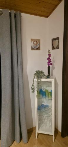a refrigerator with gray curtains next to a wall at Quartier132 - Das All-Inklusive Ferienhaus in Öfingen