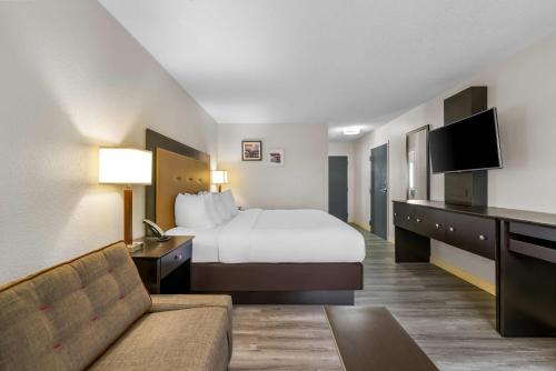 una camera d'albergo con un letto e un divano di Quality Inn Brewerton - Syracuse Oneida Lake Area a Brewerton