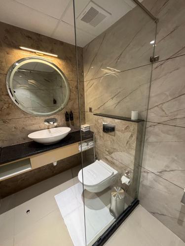 a bathroom with a sink and a toilet and a mirror at Hotel Raj Hari Palace in Jodhpur