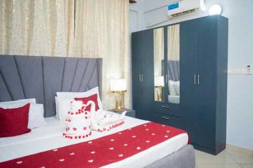 a bedroom with a bed with a red blanket at Abnaa Apartment in Zanzibar City