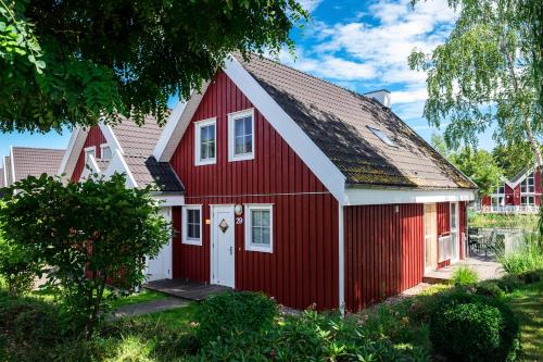 a red house with a white roof at Marinapark Scharmützelsee in Wendisch Rietz