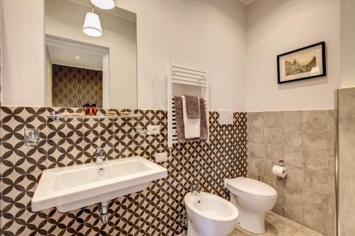 a bathroom with a sink and a toilet at The Club Navona in Rome