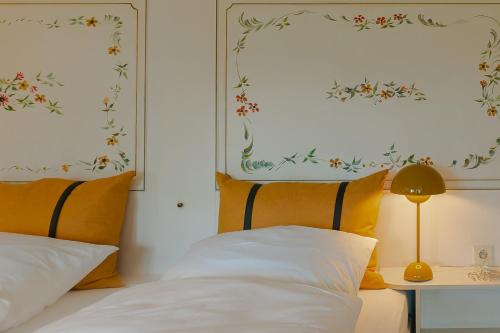 una camera da letto con un letto con cuscini gialli e bianchi di Bullerbü im Uthland a Braderup