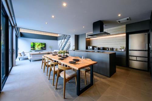 a kitchen and dining room with a table and chairs at Villa Cielo Hakone Luxury - Mt Fuji View Private Onsen & Sauna シエロ箱根仙石原 in Hakone